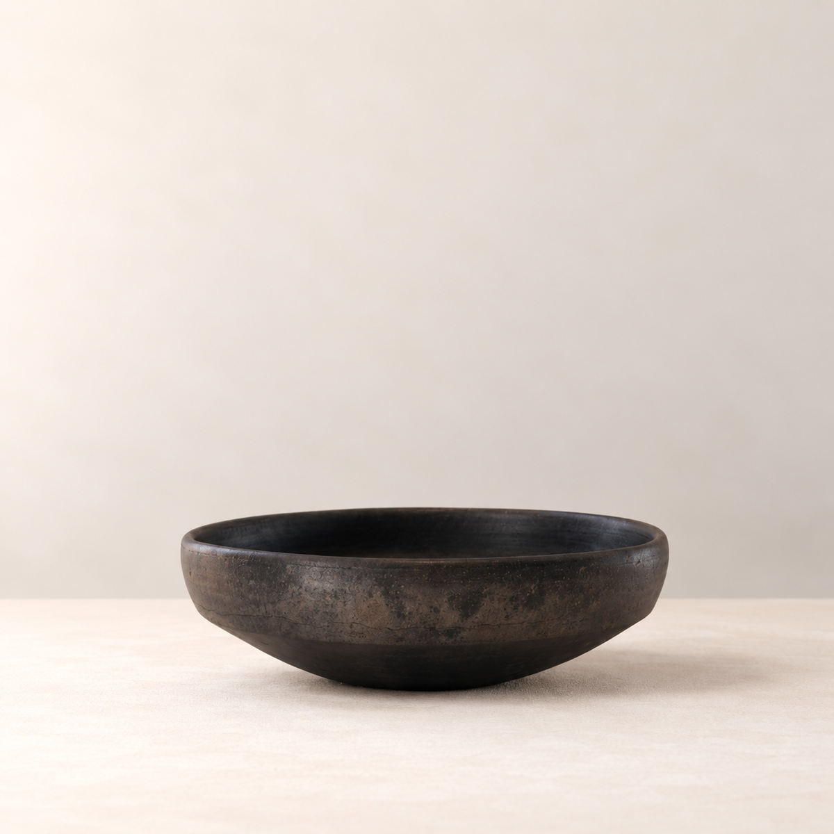 Low handmade black clay bowl by Rufina Ruiz López, side view