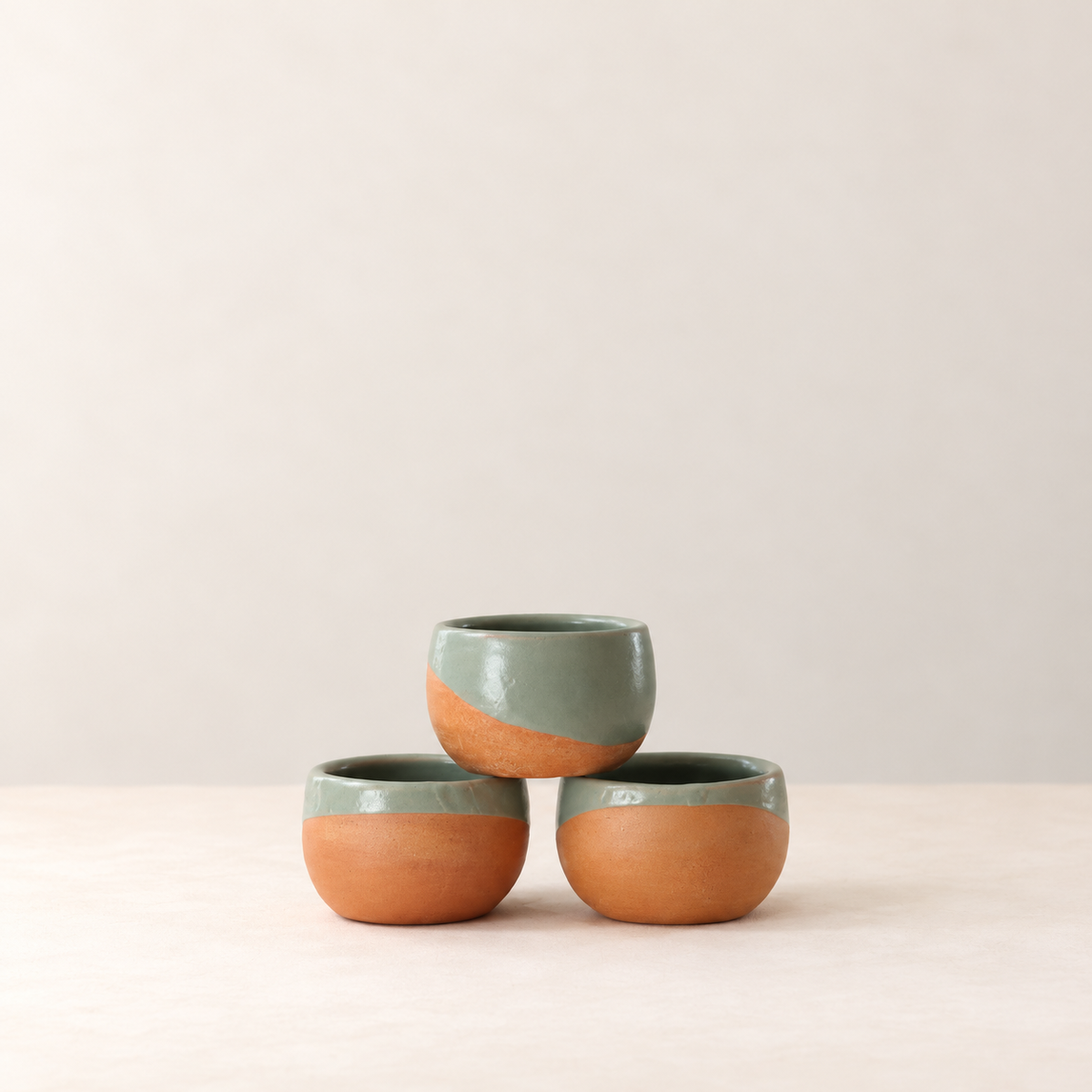 Three Rufina Ruiz Lopez handmade Oaxacan cups arranged in a triangular stack